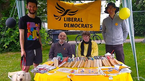 Four Lib Dems and Ayla the dog at their Respect Festival stall in Belmont Park
