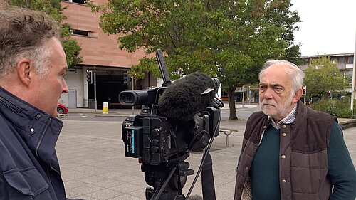 Cllr Michael Mitchell in front of an ITV Westcountry News Reporter and camera