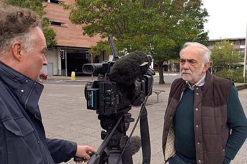 Cllr Michael Mitchell in front of an ITV Westcountry News Reporter and camera