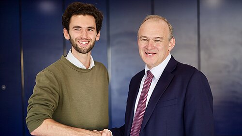 Will Aczel and Ed Davey shake hands