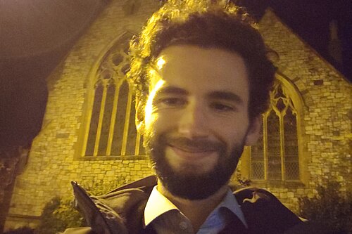 Will Aczel outside a church in Topsham