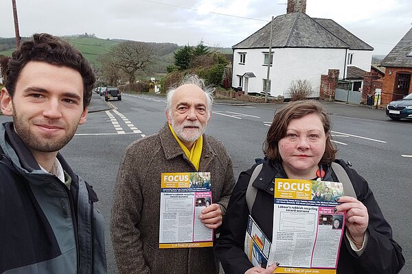 Tammy Palmer, Cllr Michael Mitchell, and Will Aczel hold up Focus Newsletters promoting 20 is plenty in front of Wrefords Lane