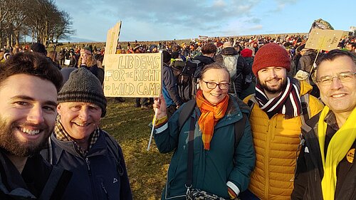 Five Devon Lib Dems at the right to wild camp protest on Dartmoor. The one in the middle holds up a sign that reads Lib Dems for the right to wild camp