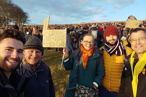 Five Devon Lib Dems at the right to wild camp protest on Dartmoor. The one in the middle holds up a sign that reads Lib Dems for the right to wild camp