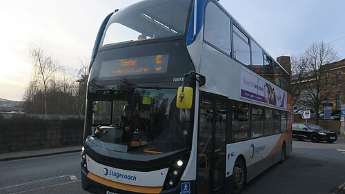 The number 5 bus crosses New North Road bridge heading towards Exeter City Centre