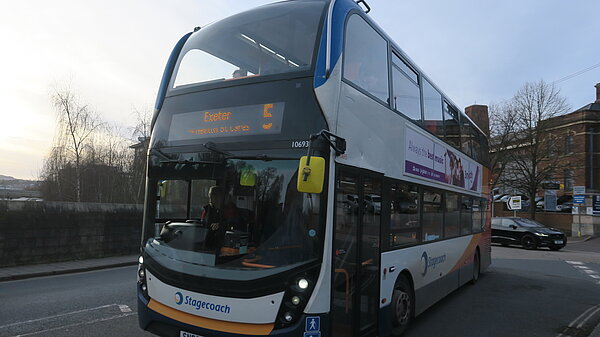 Number 5 bus crosses New North Road bridge heading into Exeter's city centre