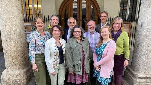 The 9 Progressive Group Cllrs on Exeter City Council stand and smile in front of Exeter Guildhall